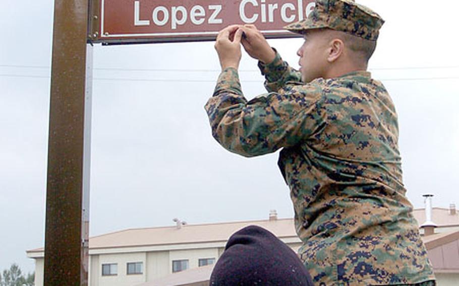Capt. Roberto Ibaita, with Marine Air Control Group-18, from Okinawa, Japan, unveils the “Lopez Circle” street sign at Camp Humphreys in Pyeongtaek. The base plans to honor key figures, organizations and equipment from the history of the U.S.-South Korean alliance.