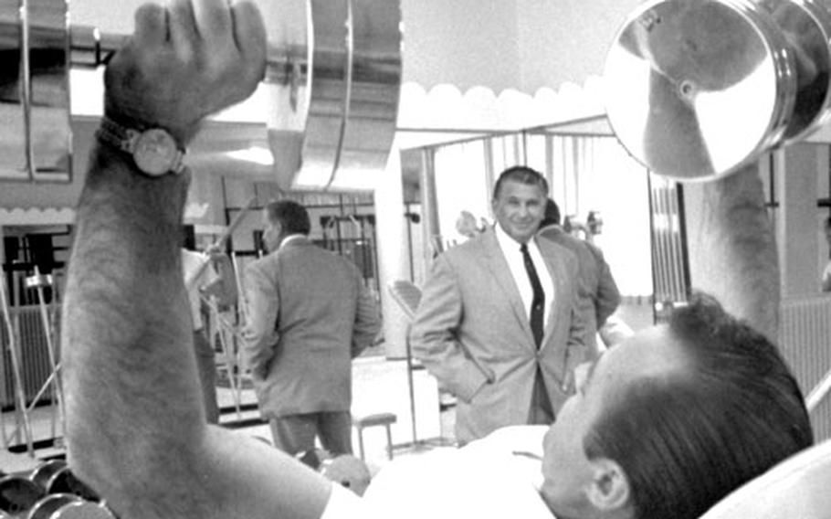 Vic Tanny, background, visits his new gym in Frankfurt, Germany, in September, 1964.