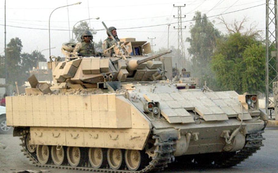 A Bradley Fighting Vehicle rolls through the streets of Samarra's Green Zone Wednesday. U.S. officials are hoping that the violence-plagued city's voters will turn out in large numbers for Saturday's constitutional referendum.
