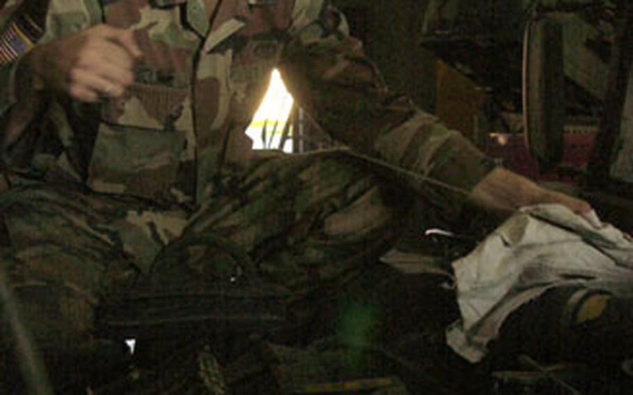 Army Spc. James Millard, the security manager for the 212th Mobile Army Surgical Hospital at Miesau Ammo Depot in Germany, checks the oil on a Humvee before deploying to Pakistan.