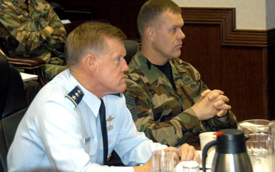 Lt. Gen. Bruce Wright, left, and Chief Master Sgt. Jim Roy listen to address by Misawa City Mayor Shigeyoshi Suzuki on Friday during the 5th Air Force Component Commanders Conference at Yokota Air Base, Japan.