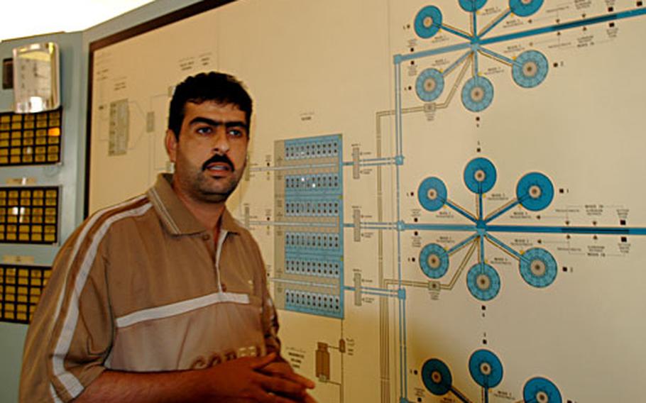 Khalid Khodir Salih, an engineer at the Khark Water Treatment Plant, shows how the plant functions. Salih said he has noticed an increase in attacks since Americans began guarding the facility. U.S. troops blame the attacks on in-fighting between the predominantly Sunni police security force and the mainly Shiite Iraqi soldiers also guarding the plant.
