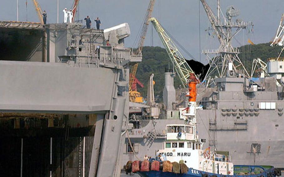 The USS Belleau Wood, based out of Sasebo Naval Base, Japan, since 1992, is shown being pulled out of the India Basin by tug boats in August 2000 for the last time. The USS Essex replaced Belleau Wood, which recently was decommissioned at Naval Station San Diego.