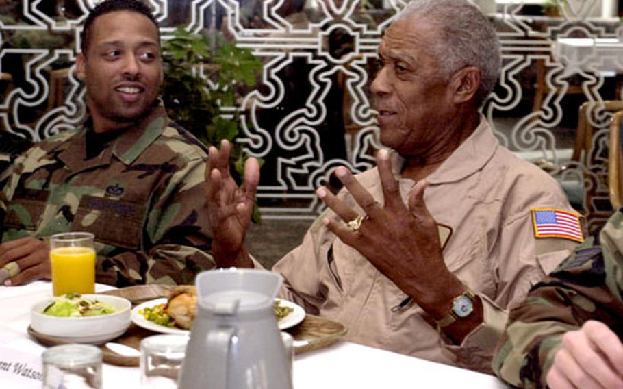 Retired Tech. Sgt. George Watson, a Tuskegee Airman, talks with airmen at Ramstein Air Base’s dining facility on Monday in Germany.