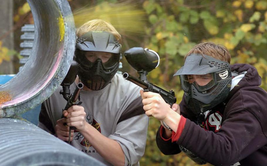 Aaron Reott, left, and James Christensen take cover as a paint ball explodes just over their heads at the paint ball field in Griesheim, Germany. The 233rd Base Support Battalion out of Darmstadt, Germany, recently won the Outstanding Installation Recreation Program in the U.S. Army for medium-sized installations.