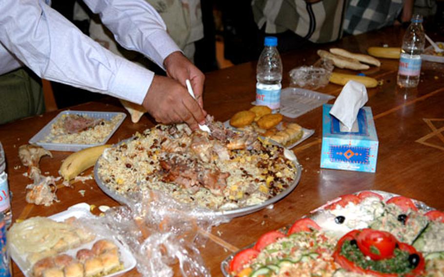 Celebrants dig into a feast, marking the end of the day’s Ramadan fast.