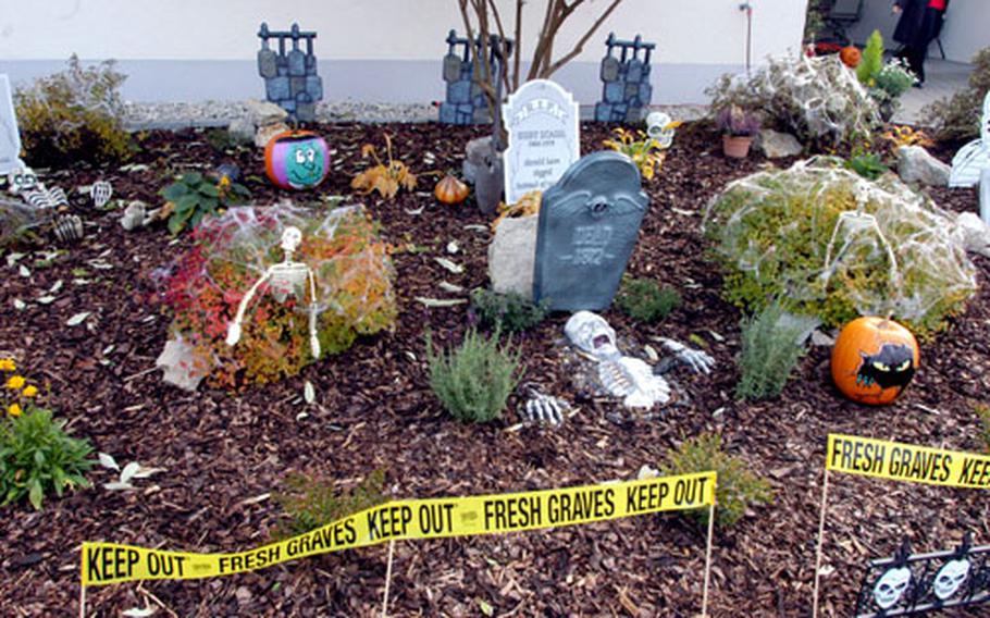 “Fresh graves” sit in the yard of Stephanie Leeds on Wednesday on Warner Barracks in Bamberg, Germany. Leeds’ yard was selected as the best decorated for Halloween. Winners were also named for best stairwell and balcony. Judges examine a stairwell Wednesday for Warner Barracks Halloween decoration contest in Bamberg, Germany. The stairwell, decorated by Beinca Bunch, took first place for the stairwell category.