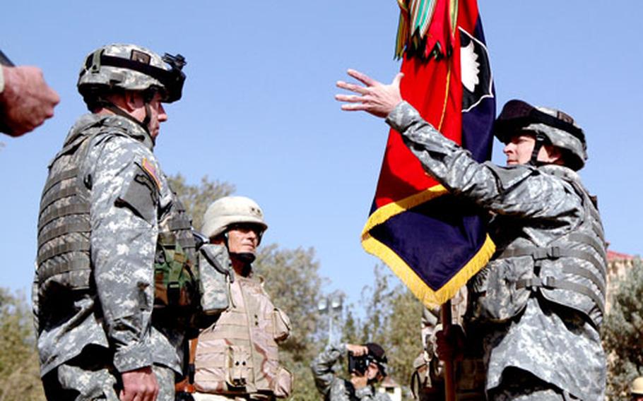 Maj. Gen. Tom Turner, right, receives the colors from Maj. Gen. Joseph Taluto, center left.