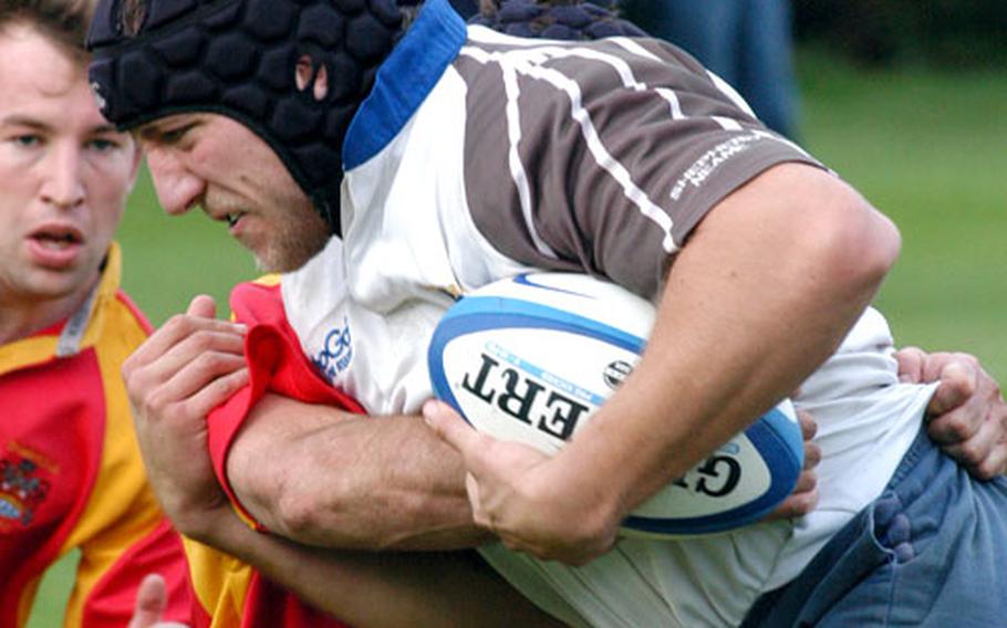 Two Cambridge Rugby Union Football Club players meet a Southend Rugby Football Club foe near the goal line in a recent test at Cambridge.