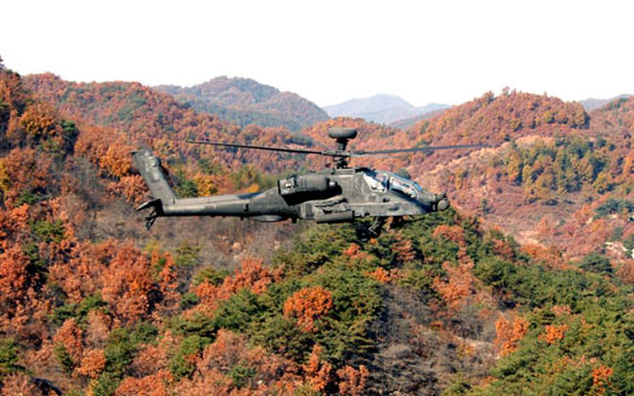 A 3rd Squadron, 6th Cavalry Regiment Apache flies above the trees at Rodriguez Range on Monday.