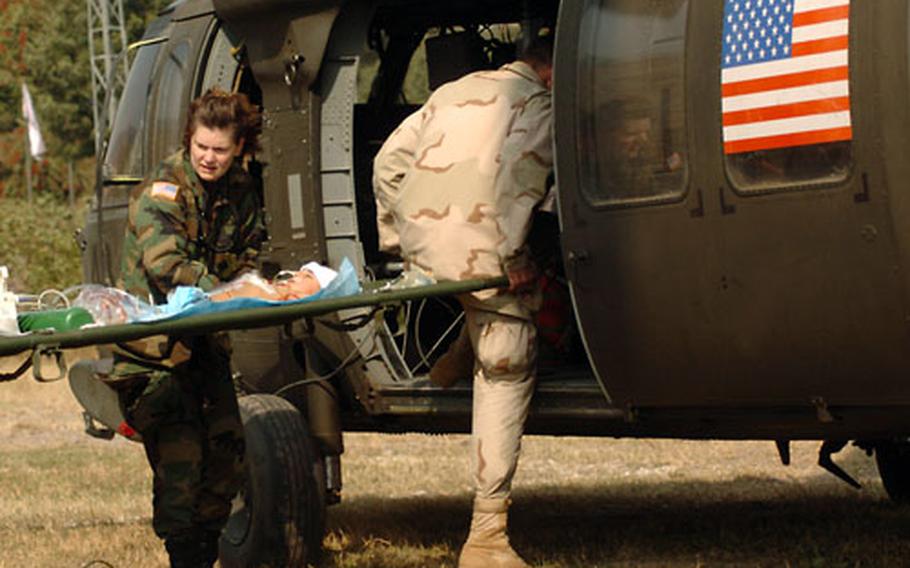 Lt. Col. Linda Lebedovych helps evacuate a baby Tuesday to an Islamabad hospital after the baby spent the previous night attached to a ventilator in the 212th MASH ICU.