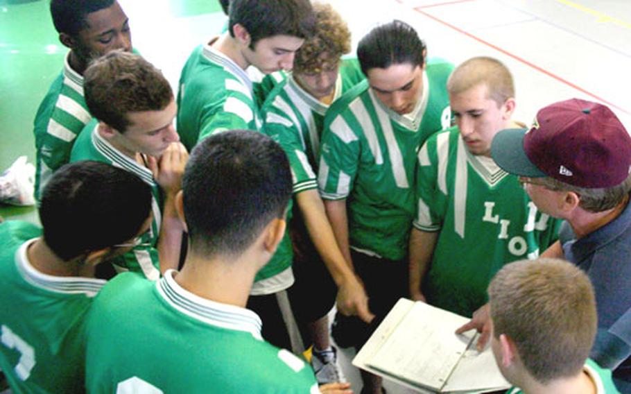 The Livorno Lions boys volleyball team takes a timeout Thursday to go over plays with coach James Bartell during preliminary round of the Mediterranean boys tournament, held this week at Naval Support Activity Naples, Italy.