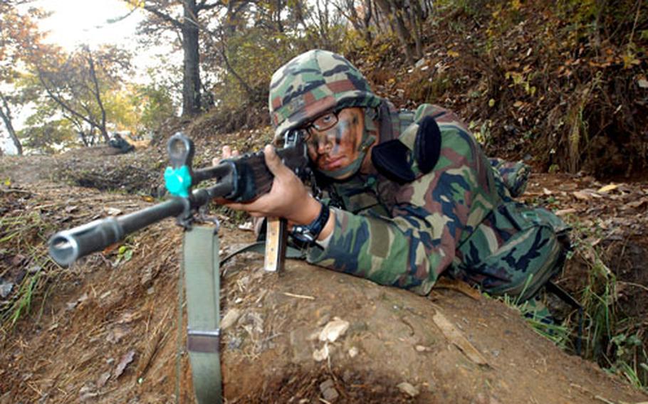 Republic of Korea soldier Pfc. Chang Chun-su guards a tactical assembly area occupied by U.S. soldiers. U.S. and ROK Army soldiers trained together at Twin Bridges on Thursday.