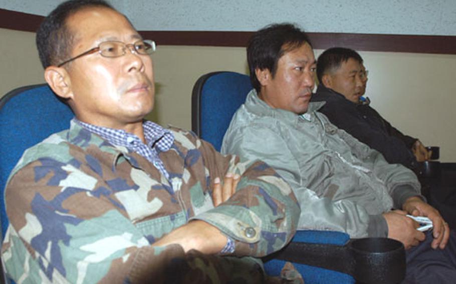 South Korea base workers listen to Area I commander Col. Forrest R. Newton at Camp Red Cloud, South Korea, on Tuesday.