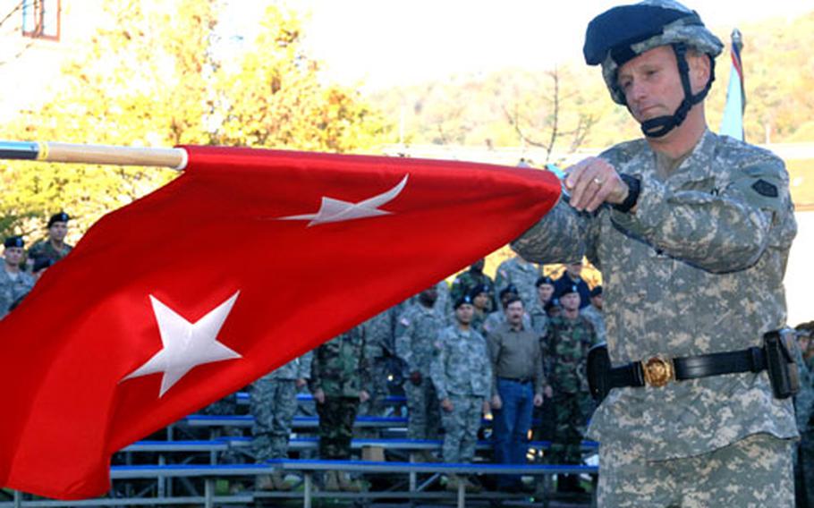 V Corps deputy commander Maj. Gen. Daniel Hahn unfurls his new two-star flag after being promoted during a Tuesday ceremony at Campbell Barracks in Heidelberg, Germany.