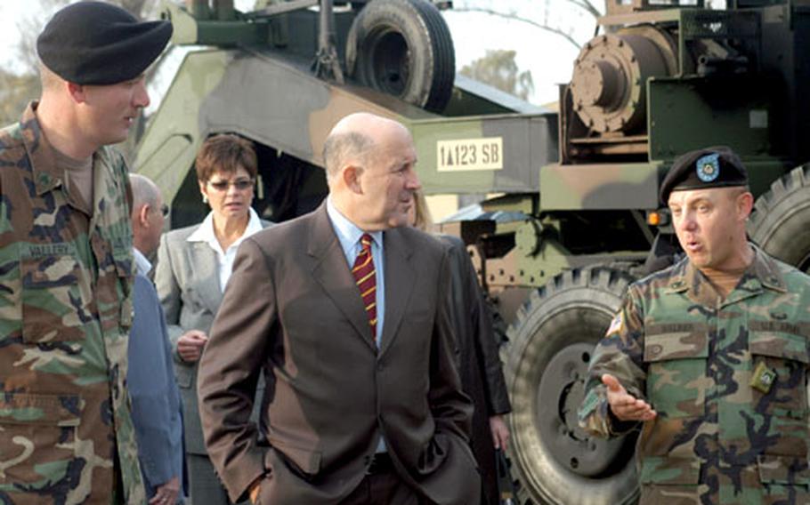 Wisconsin Gov. Jim Doyle chats with Army Sgt. Robert Vallery, left, and Staff Sgt. Arthur Walker during a Wednesday visit to Dexheim, Germany. Doyle, who is on an 8-day trade mission to three European countries, stopped in Dexheim to dine with soldiers from Wisconsin and check out heavy equipment transport trucks manufactured in Oshkosh, Wis.