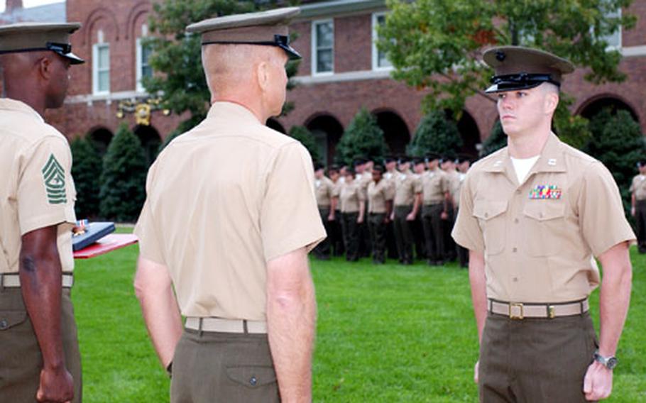 General Michael W. Hagee, center, commandant of the Marine Corps, prepares to award the Silver Star to Capt. Joshua L. Glover, right, on Oct. 28 at the Marine Barracks in Washington.