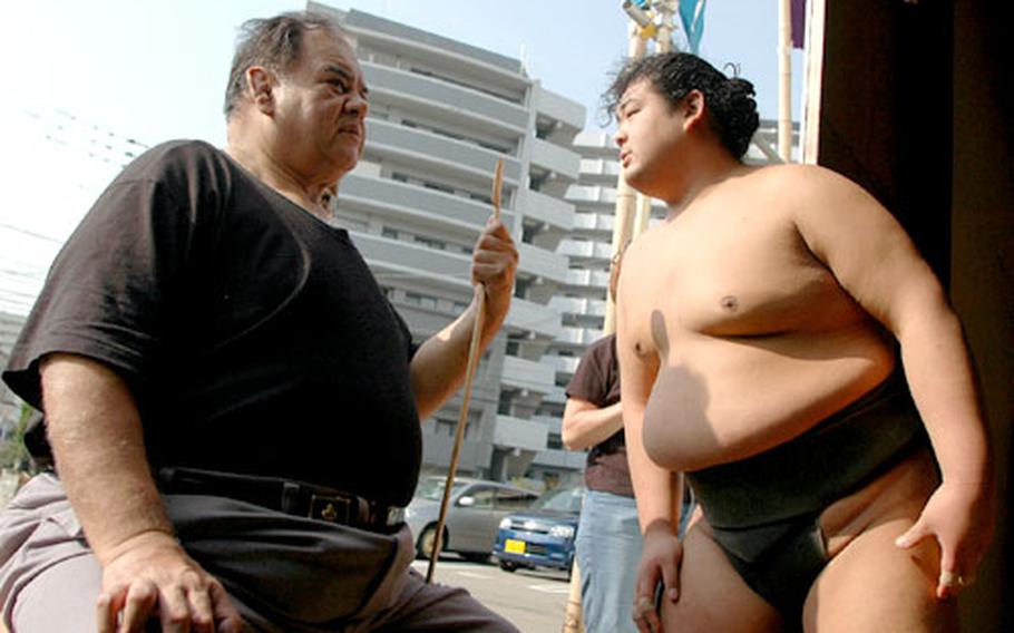 Jesse Kuhaulua, left, was born in Hawaii; wrestling as Takamiyama, he became the first non-Japanese sumo to win the Emperor's Cup. Azumazeki Oyakata, his name as a retired sumo master, watches over young sumo wrestlers at his Azumazeki beya, or sumo stable, in Fukuoka.