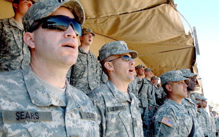 101st Airborne Division (Air Assault) soldiers sing along to the division song during Friday's Veterans Day ceremony at Forward Operation Base Warrior in Iraq.