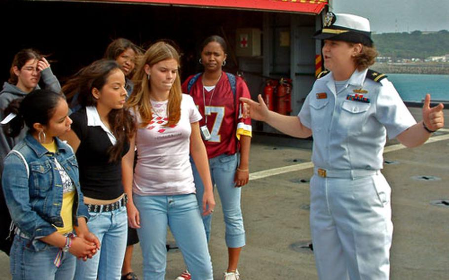 Ensign Katherine Kimsey, the USS Juneau’s weapons officer, describes flight deck operations to seniors from Kadena High School during a ship tour Wednesday at White Beach Naval Facility in Okinawa.