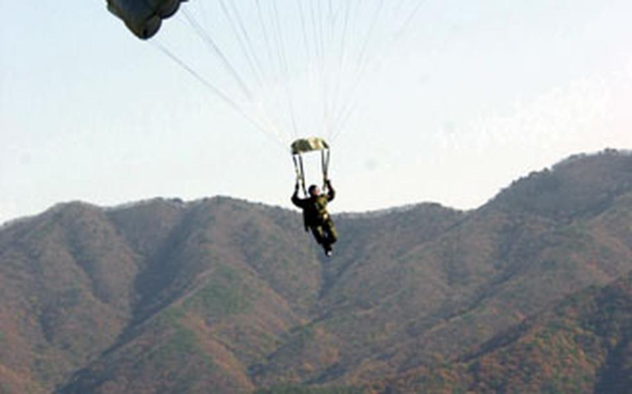 A jumper comes in for a landing at a drop zone near Seoul during jump training Wednesday.