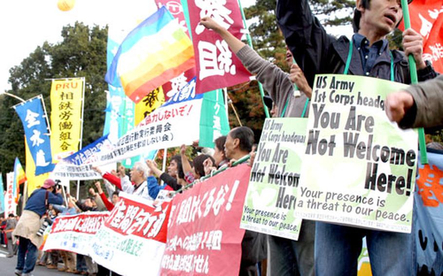 Protesters shout their opposition to an increase of troops at Camp Zama, Japan, on Saturday in front of the base’s main gate.