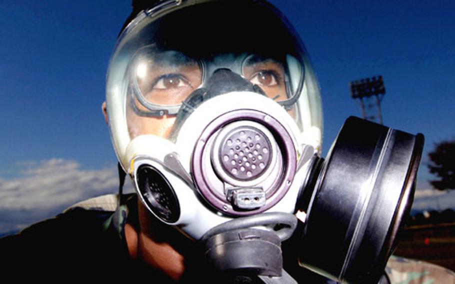 Tech. Sgt. Quincy Robinson processes through the contaminated control area during "ability to survive and operate" training at Yokota Air Base, Japan. Robinson is a member of the 374th Dental Squadron.