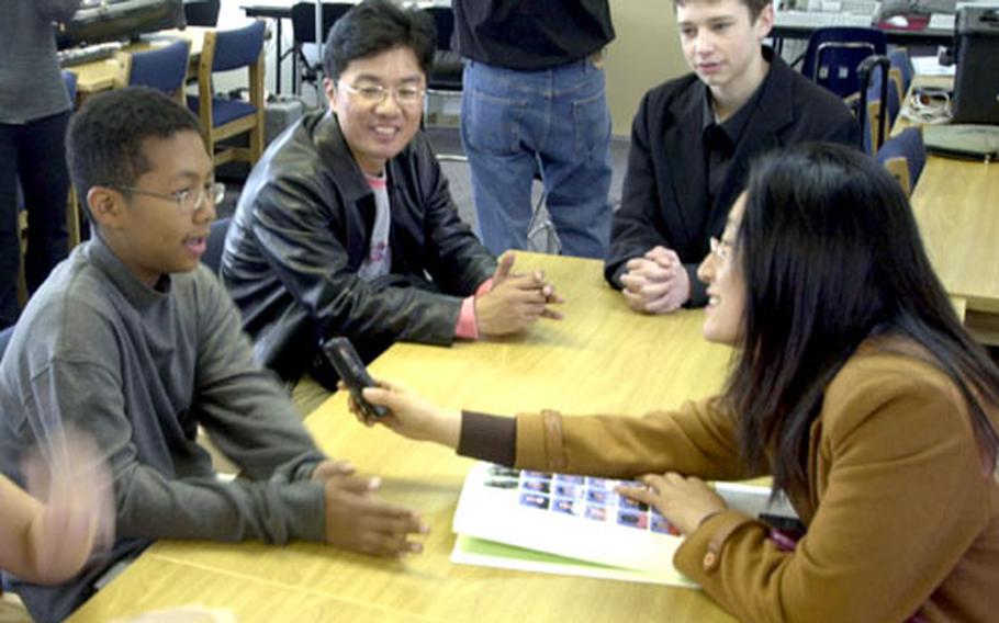 Cho Hyea-ran, a South Korean teacher, interviews pupil and volunteer guide Christopher Campbell, 13, Wednesday at Seoul American Middle School on Yongsan Garrison.