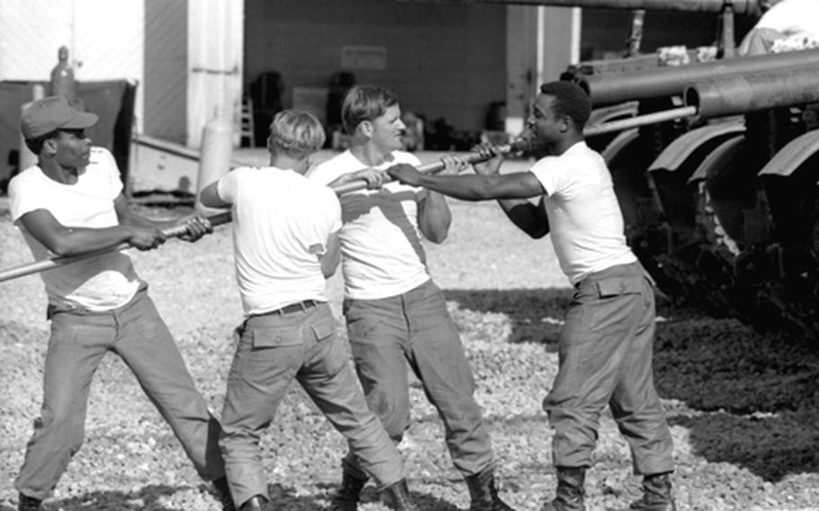 Cleaning the barrel of a tank's gun at Camp Casey, South Korea, in 1975.