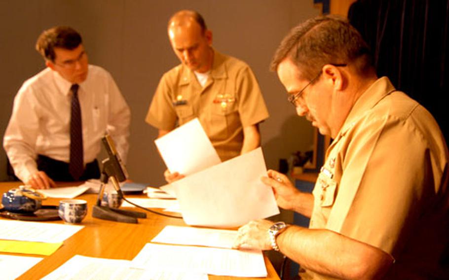 Last-minute preparations are made by Commander Fleet Activities Yokosuka Master Chief William Holz, right, CFAY Commanding Officer Cpt. Greg Cornish and CFAY spokesman Bill Doughty before "Commander’s Corner" goes on the air.
