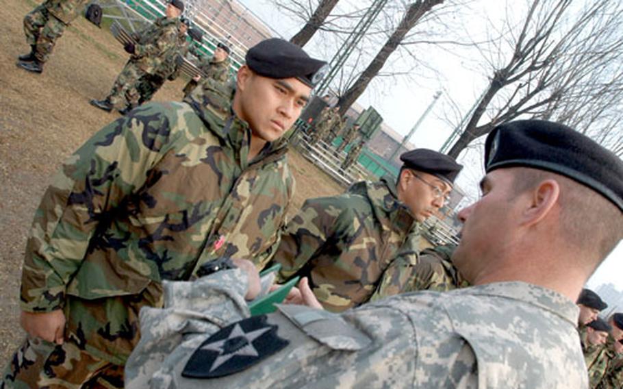 2nd Infantry Division Command Sgt. Maj. James A. Benedict pins the Bronze Star with Valor on Spc. Rodney Roby at Camp Red Cloud on Monday.