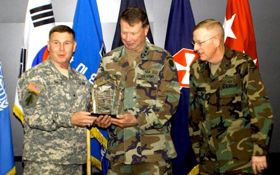 Brig. Gen. Joseph Smith, left, commanding general, United States Army Combat Readiness Center, and director of Army Safety, presents the Army Major Command Safety Award to Lt. Gen. Charles Campbell, 8th Army commanding general with the Chief of Staff, as 8th Army Command Sgt. Maj. Barry Wheeler looks on.