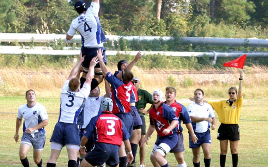 Capt. Wayne Kinsel is lifted up by his teammates as an out-of-bounds rugby ball is put back into play during the Armed Forces championships against Coast Guard last month at Camp Lejeune, N.C., where the Air Force team took first place.