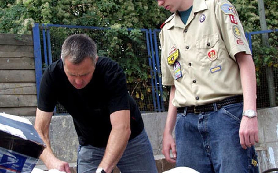 Boy Scout Dylan Baker, right, is briefed by Eduard Griesmann, technical supervisor at Hanau’s Waste Management Office in Hanau, Germany. Earlier this year, the 15-year-old Baker delved into the world of recycling for his Eagle badge project.