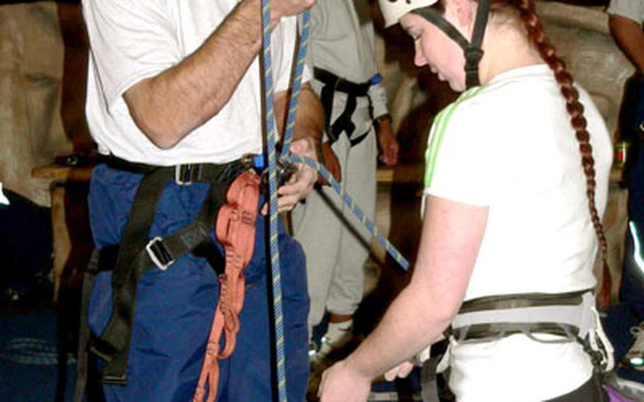 Staff Sgt. Christine Mahler, an experienced rock climber and volunteer, shows Col. Sam Angelella, 35th Fighter Wing commander, the proper technique for belaying a climber at the Weasel’s Den during Wingman Day at Misawa Air Base, Japan, on Wednesday.