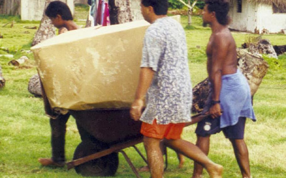 Residents of an outer island of Palau retrieve boxes from the U.S. Air Force’s 1999 Christmas drop.