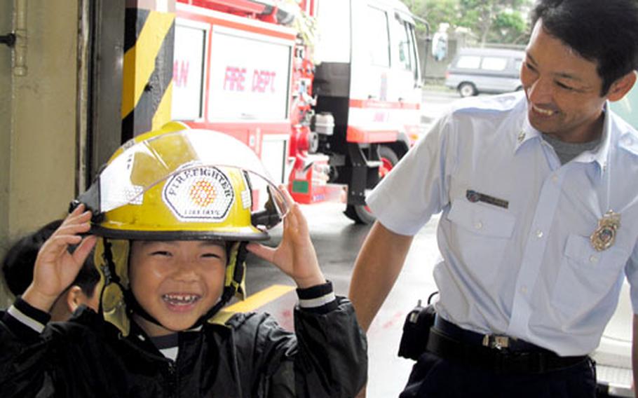 Shinnosuke Iha, 7, finds it really cool to be a firefighter Wednesday at the Camp Foster fire station.