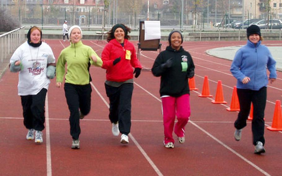 Brenda Swartz, center, and other family members from the 54th Engineer Battalion family fitness program run during the Warner Barracks Turkey Trot on Nov. 18. Swartz is the battalion’s family readiness support assistant.