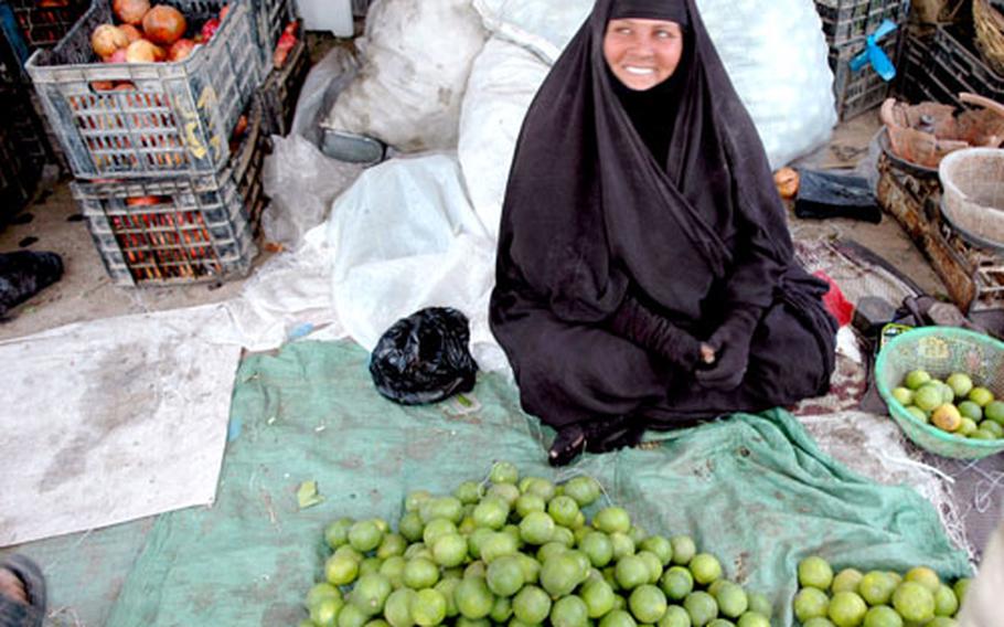 Life “is better now,” says Latifa Hussein, 50, an orange seller at a local market, who said she’s seen positive change since Saddam was removed from office.