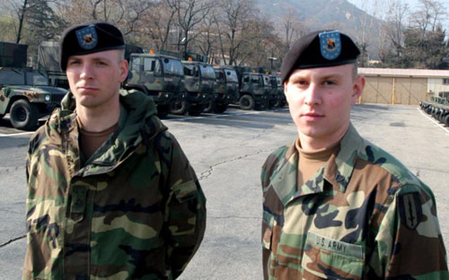 304th Signal Battalion soldiers Pfc. Richard Hearron, 24, of Fort Riley, Kan., and Pfc. Colin Coriell, 20, of Bowling Green, Ohio, in their new motorpool at Camp Stanley.