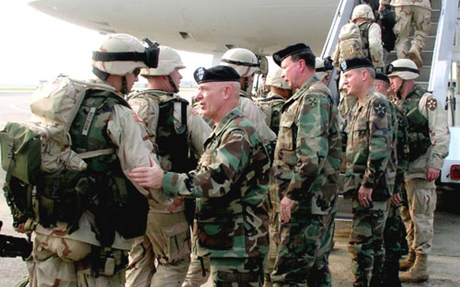 Troops of Army 2nd Infantry Division’s Strikeforce brigade board a jetliner for Kuwait and eventual duty in Iraq on Aug. 10, 2004, at Osan Air Base, South Korea. Seeing them off are senior Army brass including, left, Gen. Leon J. LaPorte, the top American commander in South Korea. To LaPorte’s right is Lt. Gen. Charles C. Campbell, commander of 8th U.S. Army, and to his right, Maj. Gen. John R. Wood, commander of the 2nd ID. LaPorte has announced that, after 38 years of service, he will retire Feb. 1.
