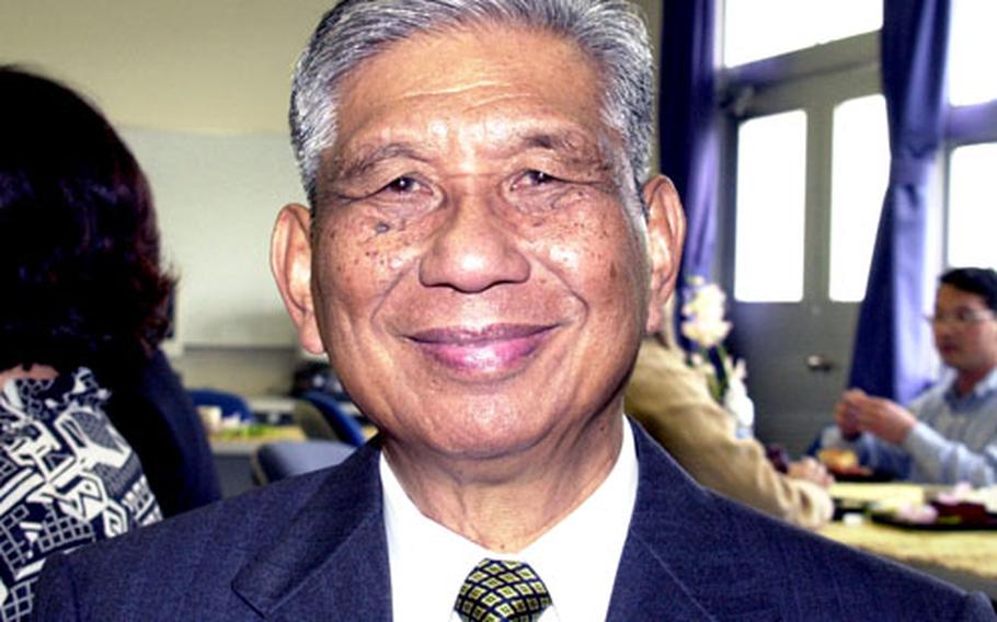 Pete Ashimine is the center of attention during a celebration of his 60th anniversary working for AAFES. Ashimine began working as a sales clerk for Army Exchange Services in the Phillipines just two months after the Japanese surrendered in WWII. He came to Okinawa in 1948.