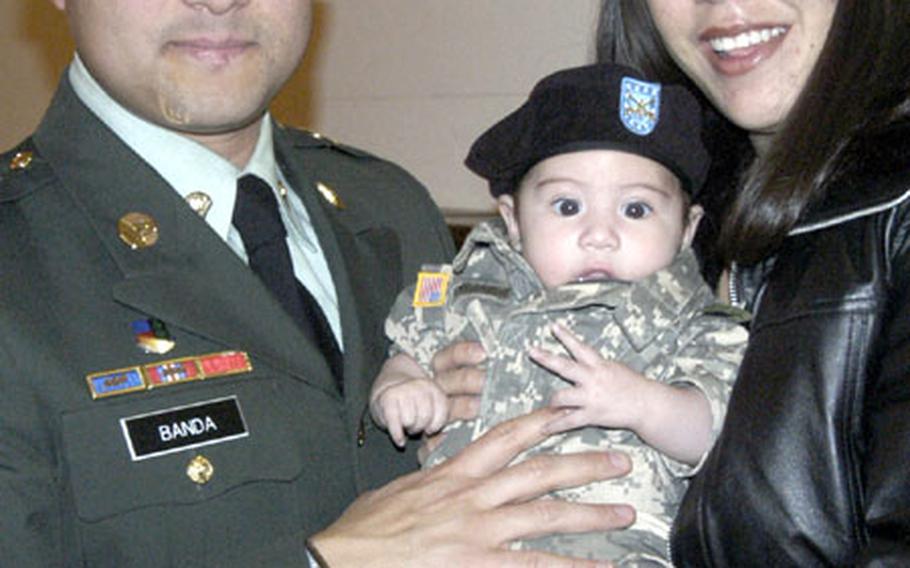 Hector Banda, originally from Mexico, with wife Melissa and two-month-old son Ethan following the military naturalization ceremony in Heidelberg, Germany, where Banda became an American citizen.