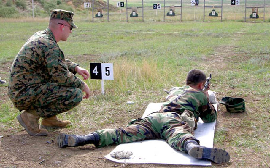 Marine Cpl. Shawn Isbell coaches a soldier from the Georgian 22nd Light Infantry Battalion on the range at Krtsanisi, Republic of Georgia, in September.