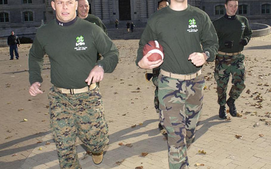 Members of 13th company, at the start of the running of the game ball from the U.S. Naval Academy in Annapolis, Md., to Philadelphia. From left: 13th company officer Marine Corps Capt. Joseph Groah and 13th company commander Midshipman 1st Class Ronald Torgeson, carrying the ball. Behind them are, from left, Senior Chief Petty Officer Jeffrey Carlsen, Midshipman 1st Class Matt Mangaran and Midshipman 1st Class Mark Bender.