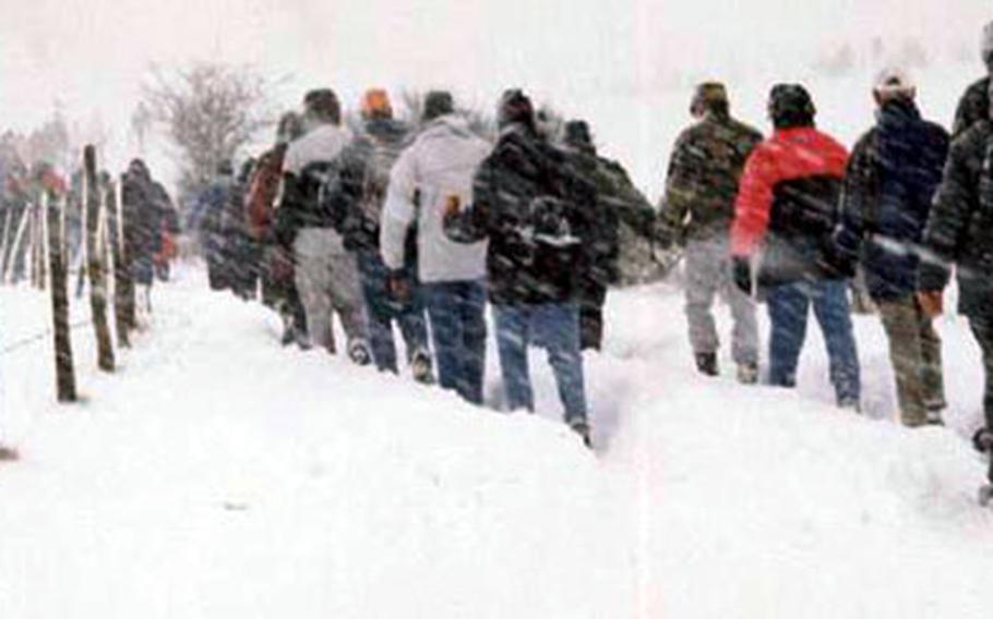 Participants to the 2003 edition of the Historical Walk in Bastogne slowly progress in the snow. They experienced the same weather conditions soldiers taking part in the Battle of the Bulge did in 1944. This year, the walk will be on Dec. 17, departing at 8 a.m. from the Bastogne Sports Center.