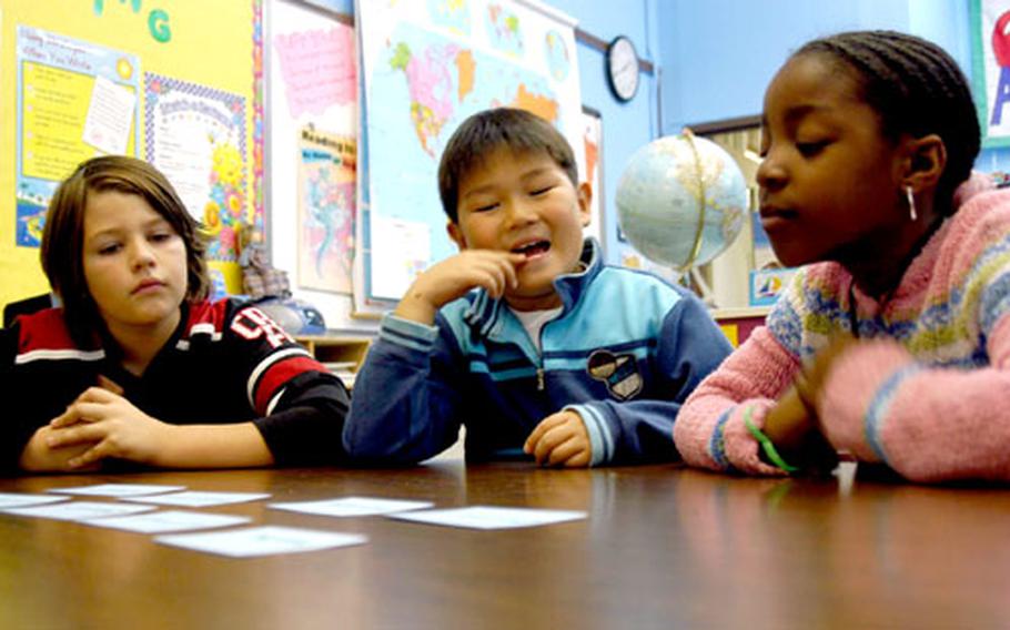 From left, Nicholas Ahlers, Simon Nutter and Maya Washington work on a lesson about the prefixes, roots and suffixes that make up some words Nov. 7. These fourth-graders at Seoul American Elementary School are among 88 students now enrolled in a literacy program meant to boost reading, writing and comprehension skills.