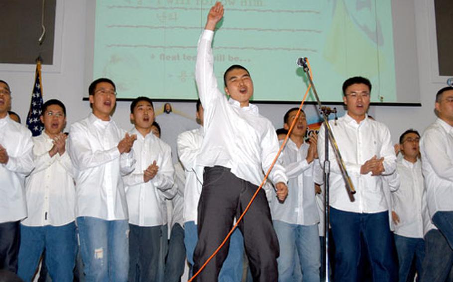 Cpl. Kim Dong-woo, 21, sings with other South Korean soldiers Friday during a talent contest on Yongsan Garrison. Kim works with the 2nd Infantry Division north of Seoul, and his group took second place in the contest.