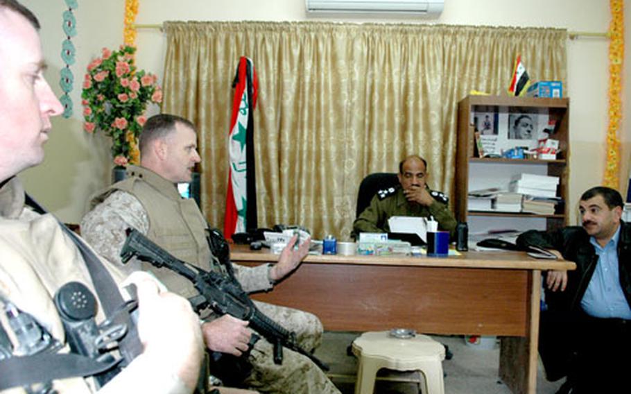 U.S. Marine Corps Lt. Col. Jim Minick meets with Fallujah police officials to discuss setting up a new police department in the suburban city of Karmah.