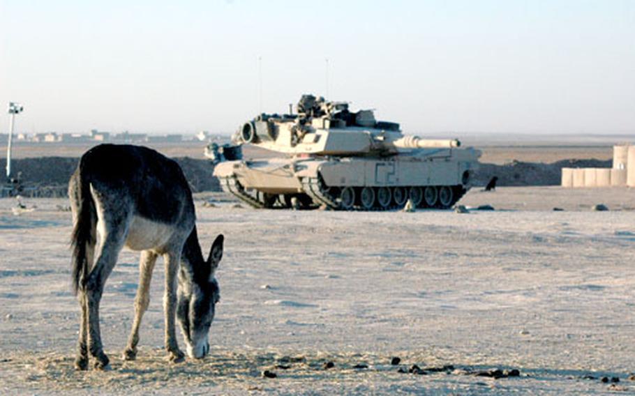 An Abrams tank from Apache Troop, First Squadron, 3rd Armored Cavalry Regiment takes position during a cordon and search operation Friday in the town of Bi&#39;aj.